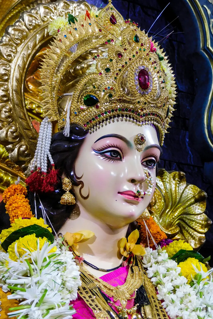 Sri Durga Devi, a close view of the goddess in a gold crown with flower garlands